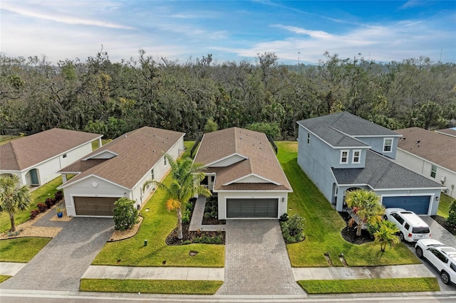 drone / aerial view featuring a residential view and a view of trees