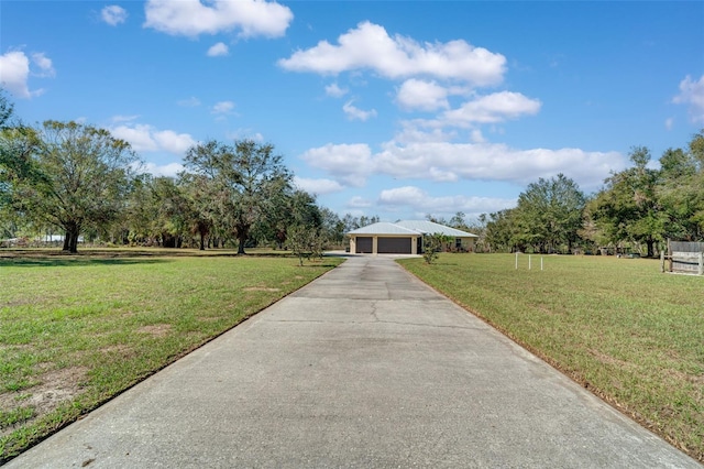 view of front of property with a garage and a front lawn