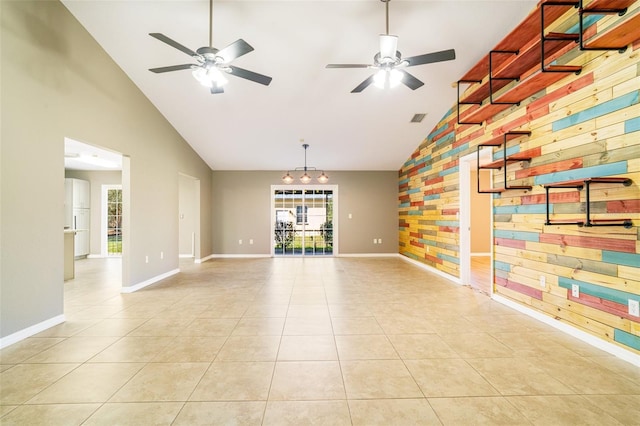 unfurnished living room with ceiling fan, high vaulted ceiling, and light tile patterned floors