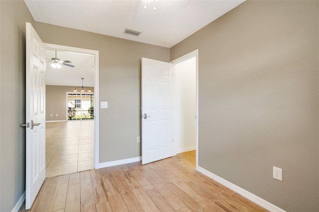 spare room featuring light hardwood / wood-style floors and ceiling fan