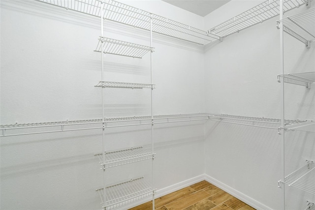 walk in closet with hardwood / wood-style floors