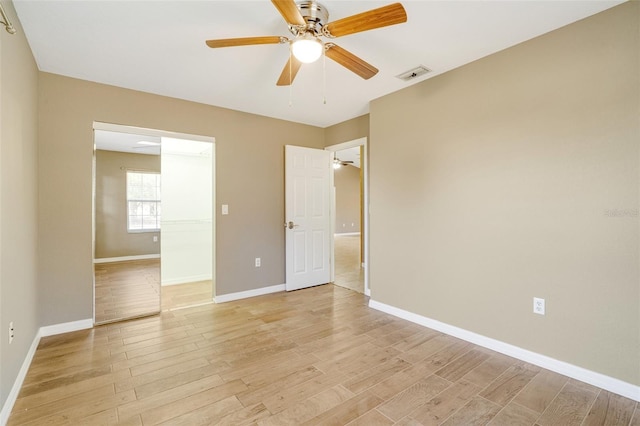 unfurnished bedroom with ceiling fan and light wood-type flooring