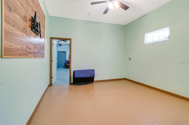 spare room featuring concrete floors and ceiling fan