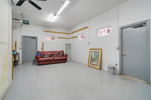 garage with a garage door opener and ceiling fan