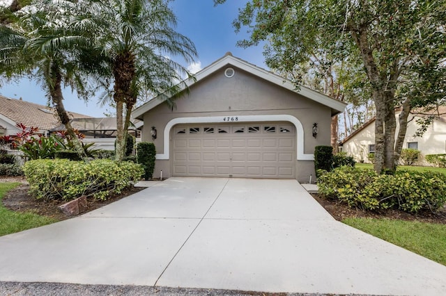 view of front of house with a garage and a lanai