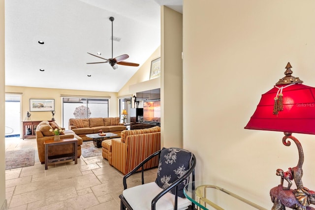 living room with ceiling fan and high vaulted ceiling