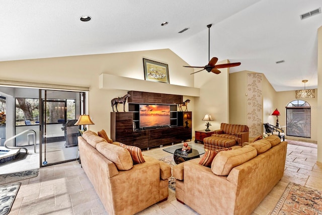 living room featuring ceiling fan, a fireplace, and high vaulted ceiling