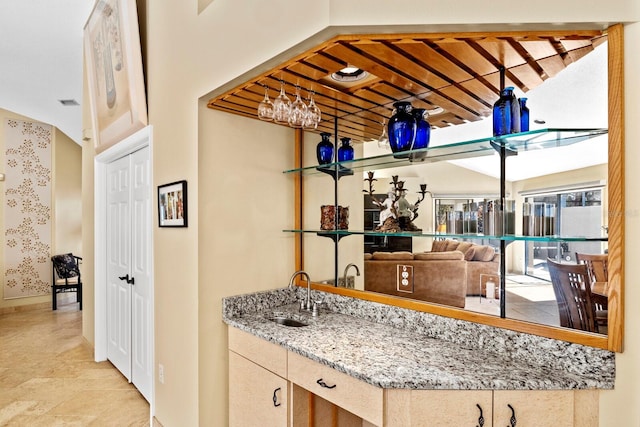 kitchen with sink and light stone countertops