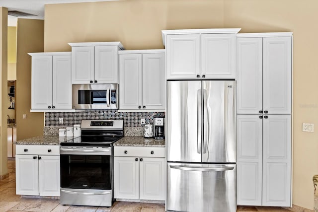 kitchen featuring light stone counters, white cabinetry, tasteful backsplash, and stainless steel appliances