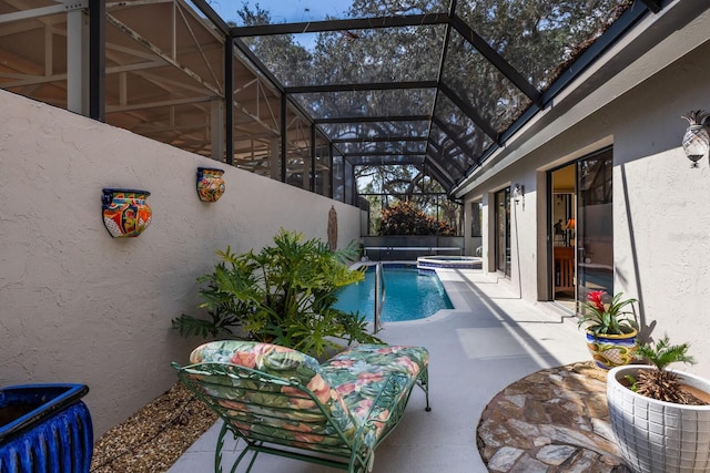 view of swimming pool with an in ground hot tub, a lanai, and a patio area