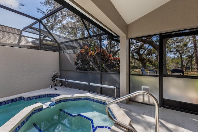 view of swimming pool featuring a lanai, a patio, and an in ground hot tub