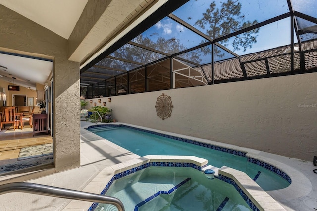 view of swimming pool with an in ground hot tub, a lanai, and a patio