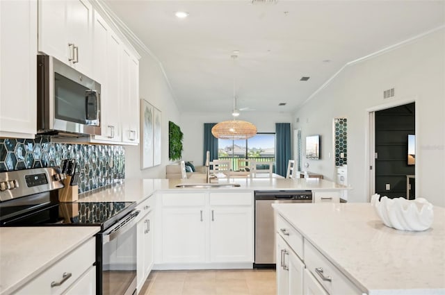 kitchen with white cabinetry, appliances with stainless steel finishes, sink, and kitchen peninsula