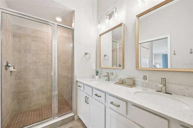 bathroom featuring vanity and a shower with door