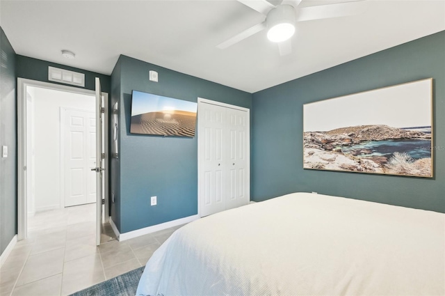 bedroom featuring a closet, ceiling fan, and light tile patterned flooring