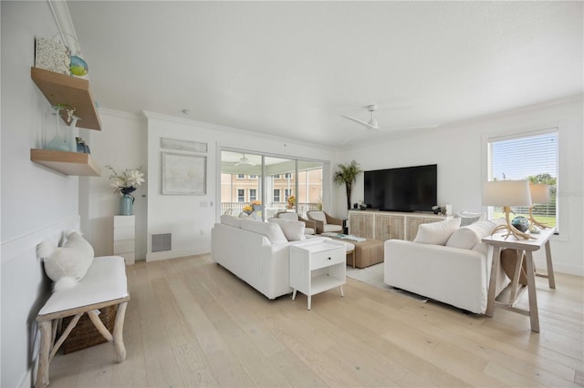 living room with a wealth of natural light, ceiling fan, and light hardwood / wood-style flooring