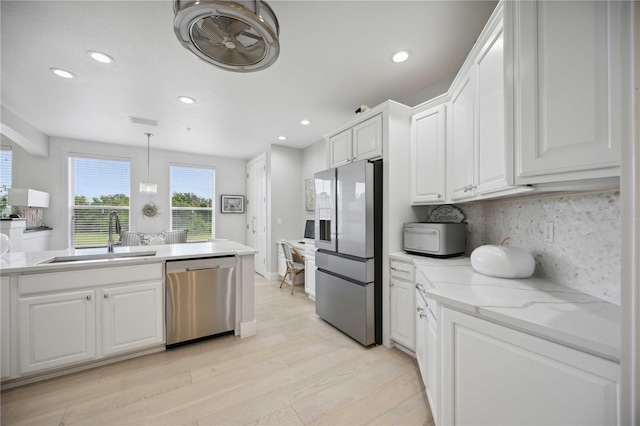 kitchen with white cabinetry, appliances with stainless steel finishes, and sink