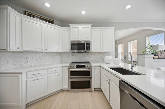 kitchen with sink, stainless steel appliances, and white cabinets