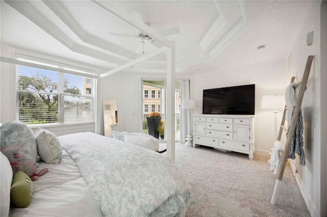 carpeted bedroom featuring a raised ceiling, ornamental molding, and ceiling fan