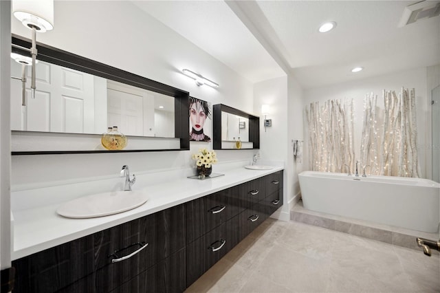 bathroom with vanity, tile patterned flooring, and a tub