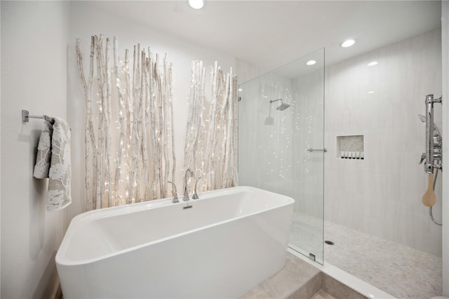 bathroom featuring shower with separate bathtub