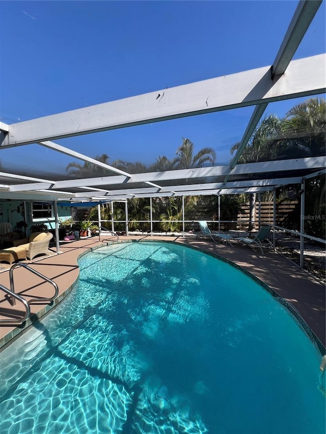 view of pool with glass enclosure