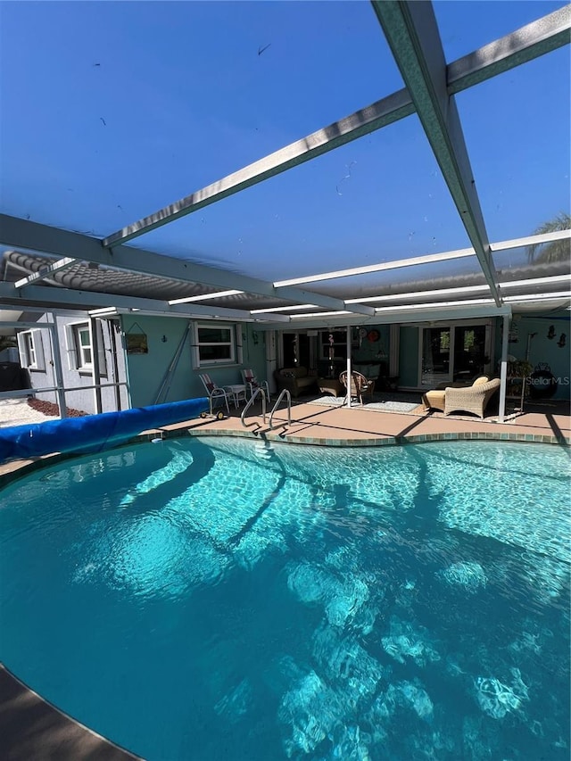 view of pool featuring a lanai and a patio