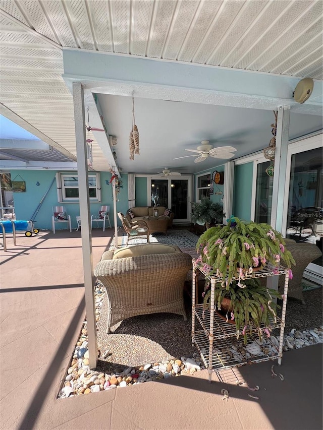 view of patio with an outdoor living space and ceiling fan