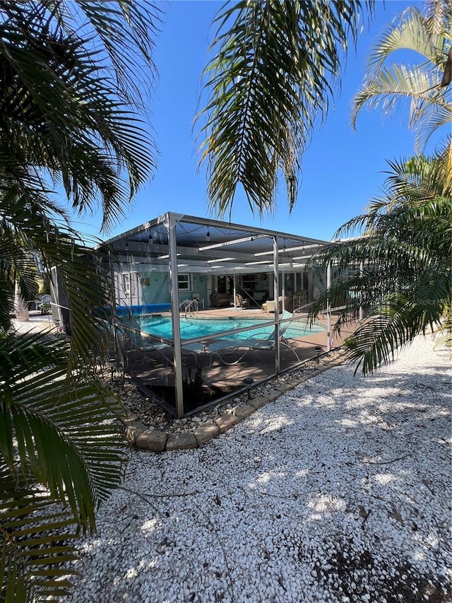 view of pool with glass enclosure