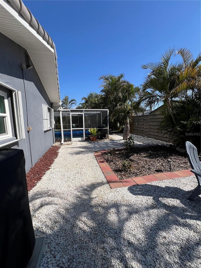 view of yard featuring a patio and a sunroom