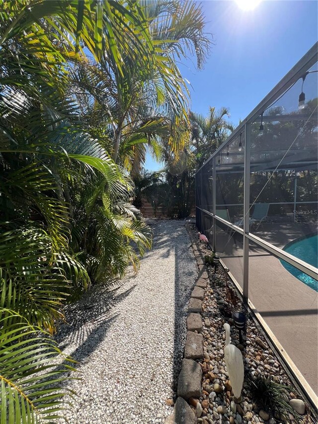 view of yard with glass enclosure