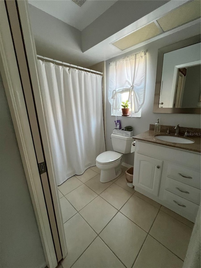 bathroom featuring tile patterned flooring, vanity, and toilet