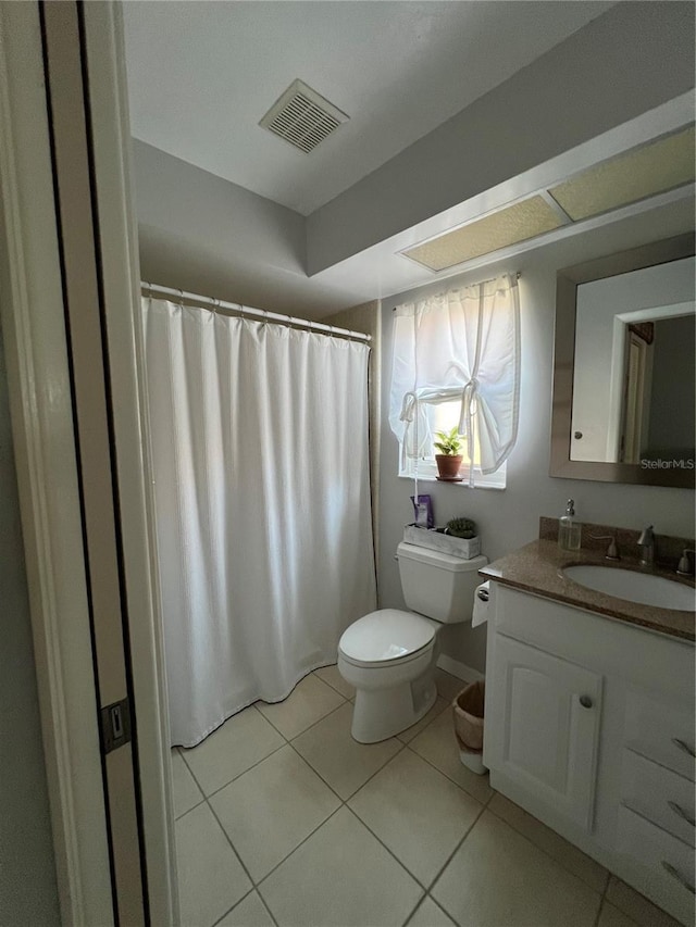 bathroom with vanity, tile patterned floors, and toilet