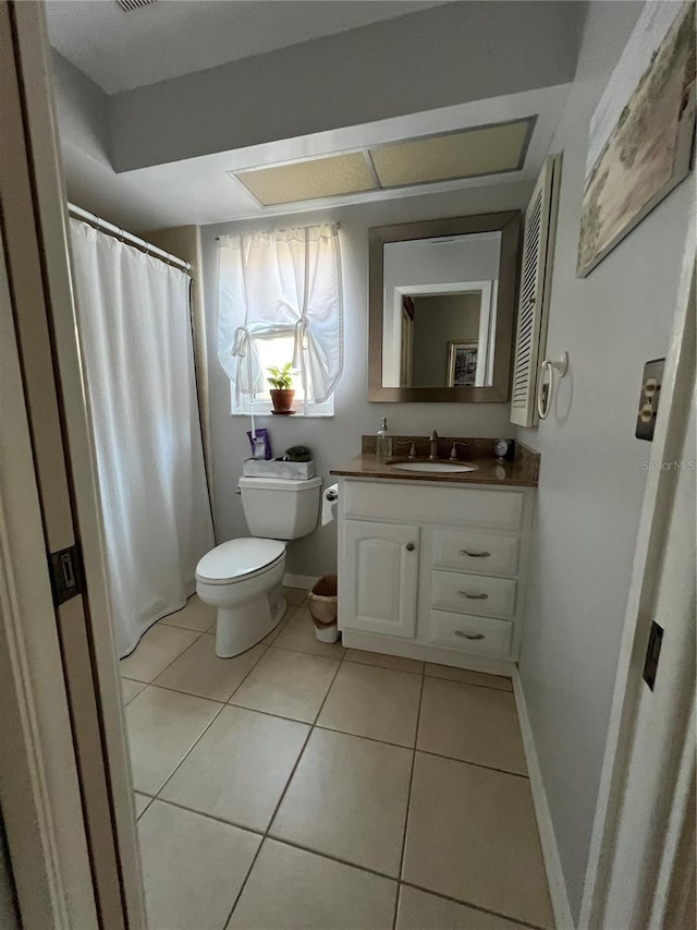 bathroom featuring tile patterned flooring, vanity, and toilet