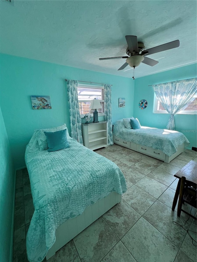 bedroom with tile patterned floors and ceiling fan