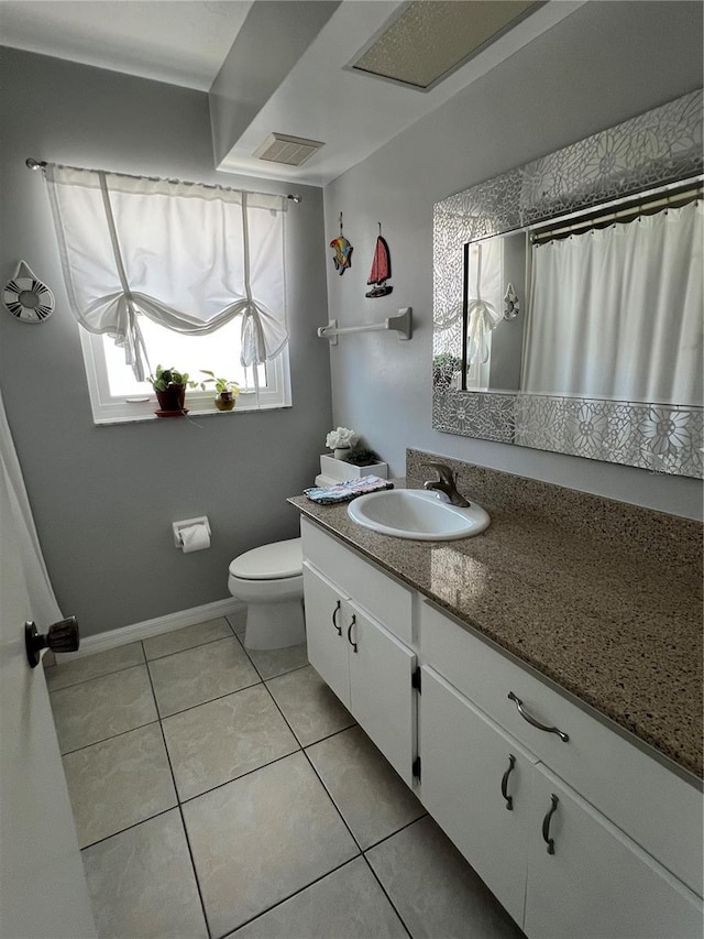 bathroom with tile patterned floors, vanity, and toilet