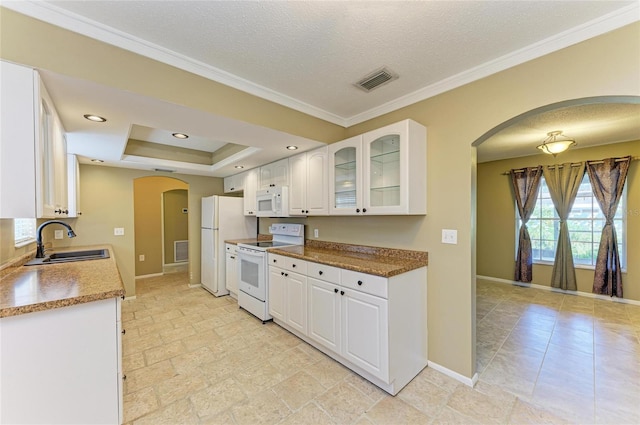 kitchen featuring white appliances, a raised ceiling, sink, and white cabinets