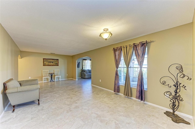 living area with a textured ceiling