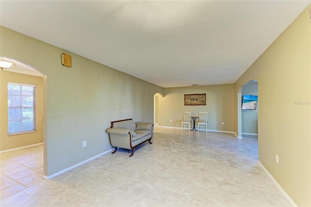 living area featuring a textured ceiling