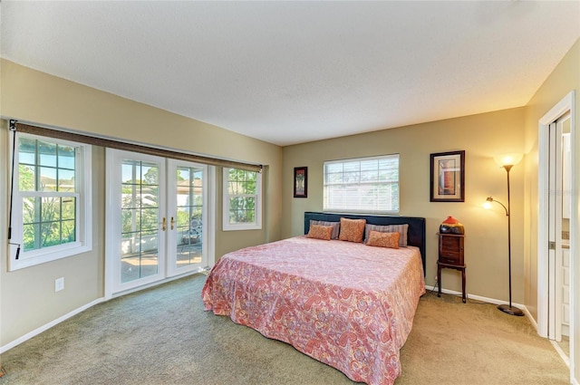 bedroom featuring light carpet, access to exterior, a textured ceiling, and french doors