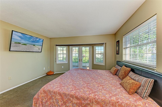 carpeted bedroom featuring access to outside, a textured ceiling, and french doors