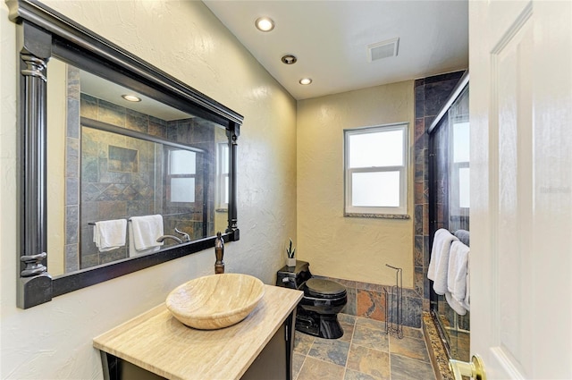 bathroom featuring vanity, toilet, and an enclosed shower