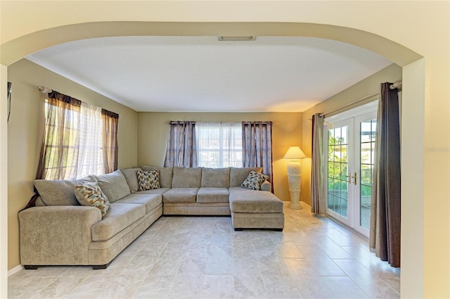 living room with a healthy amount of sunlight and french doors