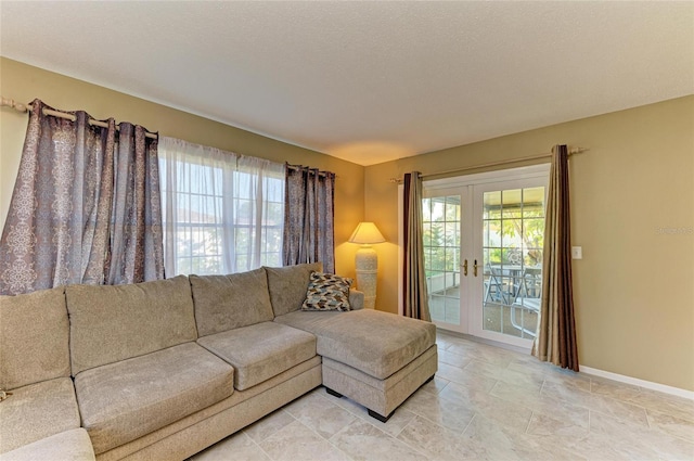 living room with a textured ceiling and french doors