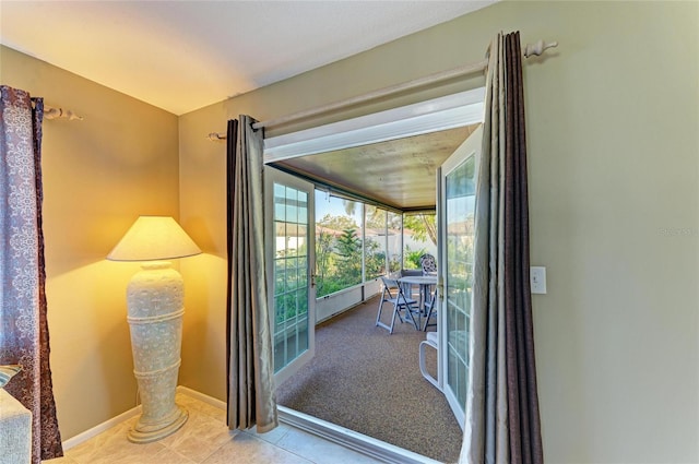 doorway with light tile patterned flooring