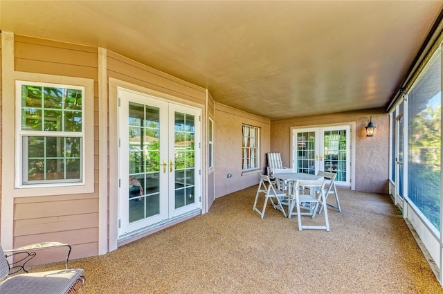 sunroom / solarium featuring french doors