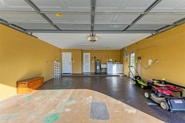 garage with water heater, sink, electric panel, a garage door opener, and washing machine and dryer