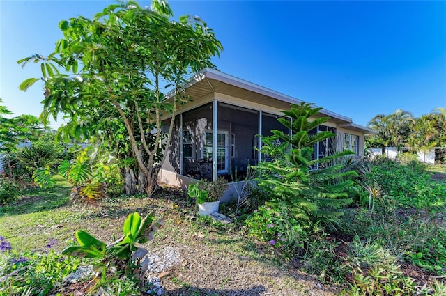 view of side of property featuring a sunroom