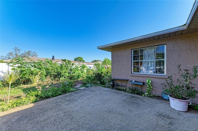 view of side of home featuring a patio