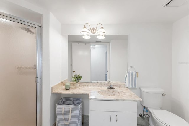 bathroom featuring vanity, a shower with shower door, toilet, and an inviting chandelier